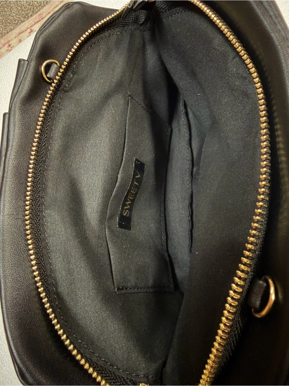 Sleek Black Fold-Detail Wristlet Clutch with Gold Zip